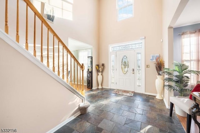 entryway featuring a towering ceiling