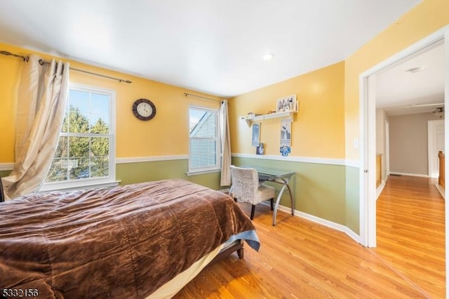 bedroom featuring light hardwood / wood-style flooring and multiple windows