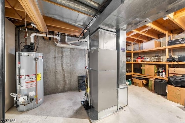 utility room featuring heating unit and gas water heater