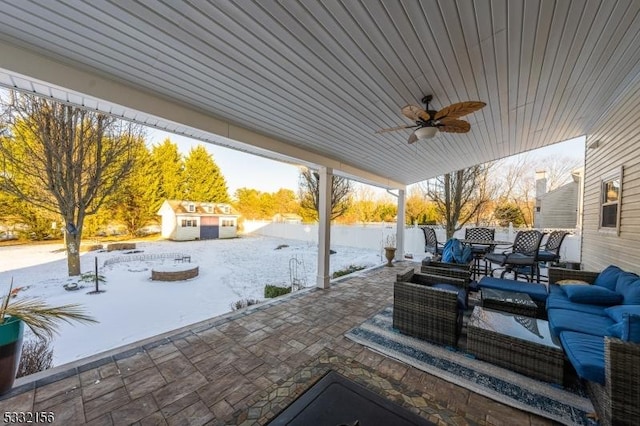 view of patio featuring outdoor lounge area, ceiling fan, and an outbuilding