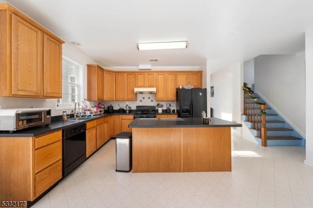 kitchen with sink, a kitchen island, and black appliances