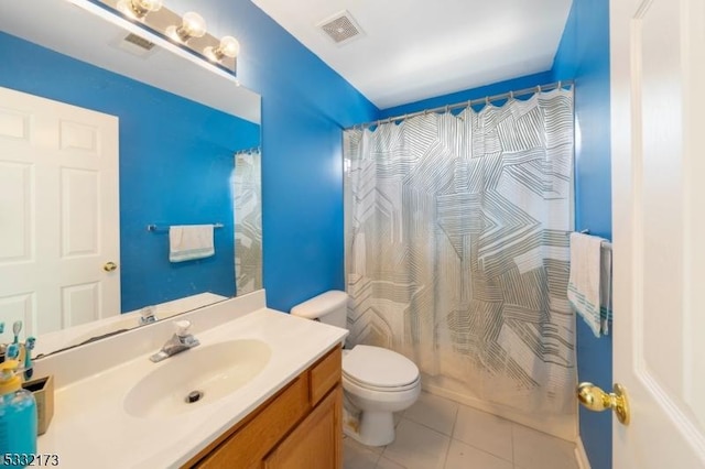 full bathroom featuring shower / bath combo with shower curtain, tile patterned flooring, vanity, and toilet