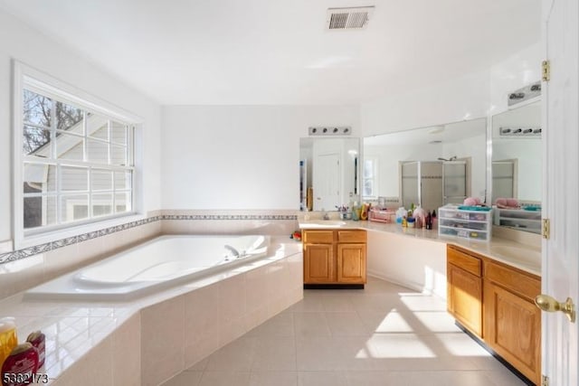 bathroom with tile patterned floors, vanity, and separate shower and tub