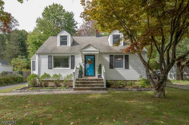 cape cod home with a front lawn