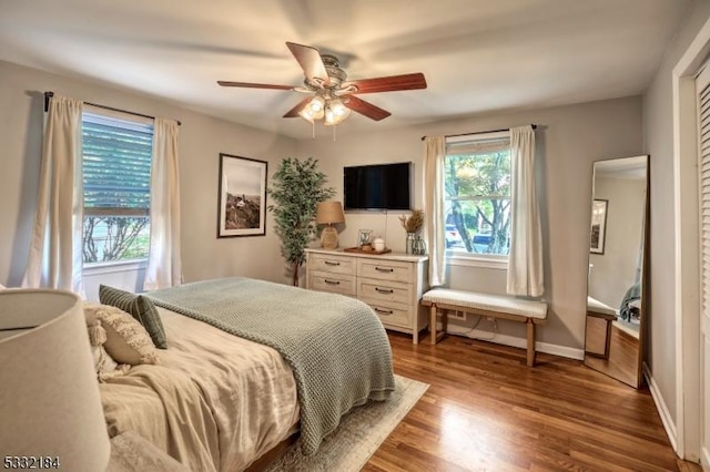 bedroom with ceiling fan and hardwood / wood-style flooring