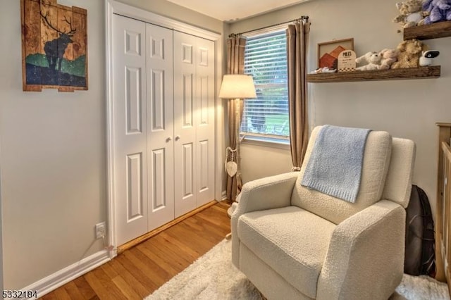 sitting room with hardwood / wood-style flooring