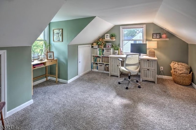 carpeted home office with vaulted ceiling