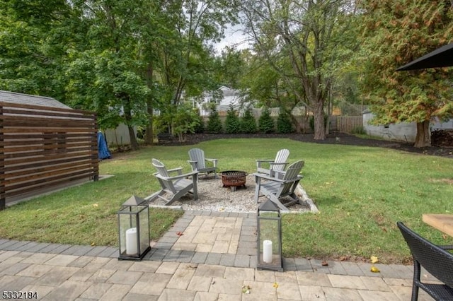 view of yard with a patio and a fire pit