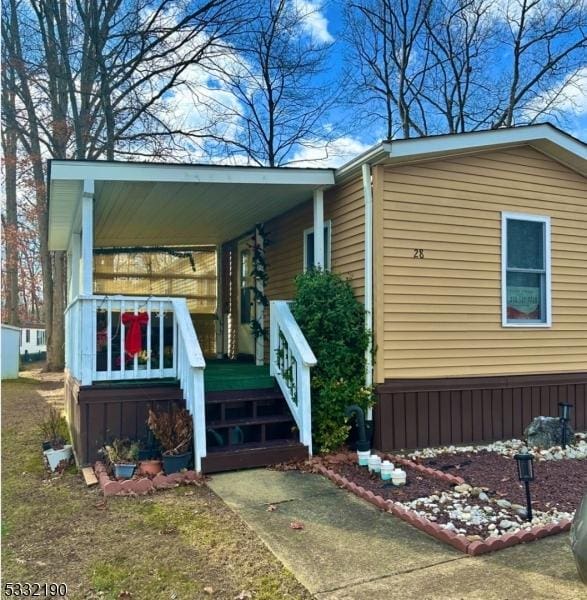 view of property exterior featuring covered porch