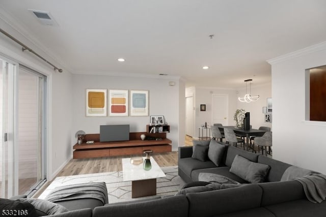 living room featuring light hardwood / wood-style floors and crown molding