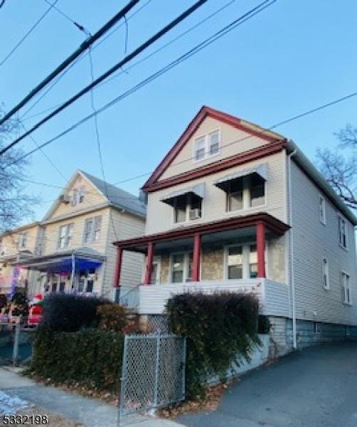 view of front facade with central AC and covered porch