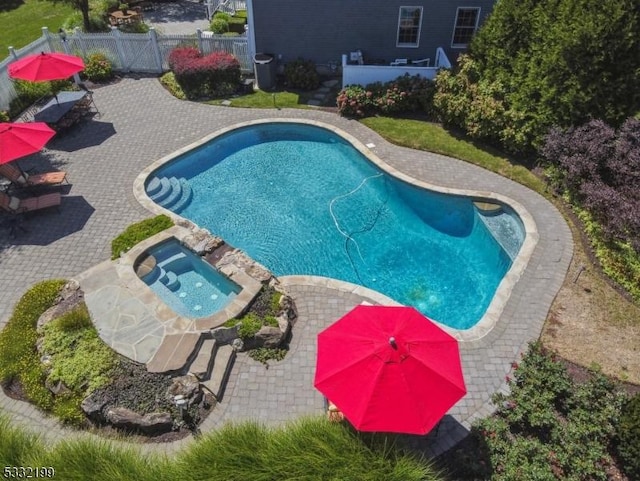 view of pool featuring an in ground hot tub and a patio