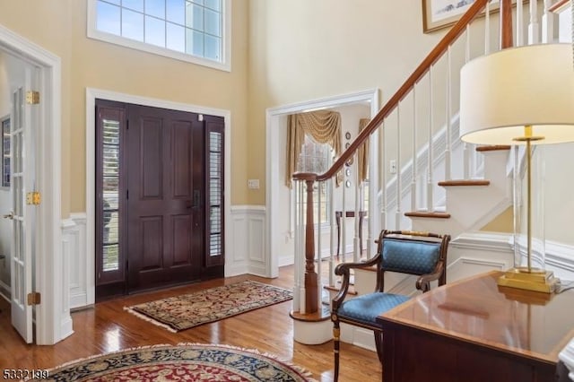 entrance foyer featuring hardwood / wood-style floors and a high ceiling