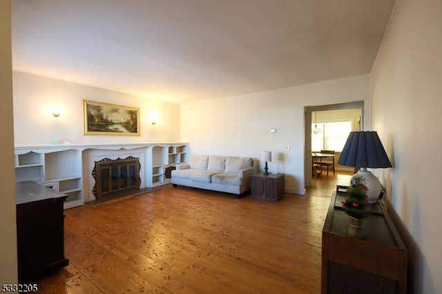 living room with a premium fireplace and hardwood / wood-style flooring