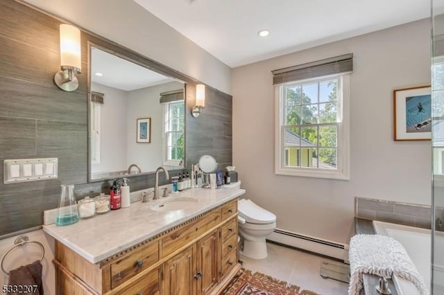 bathroom with a baseboard heating unit, vanity, tile patterned flooring, and a healthy amount of sunlight