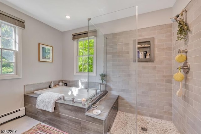 bathroom featuring independent shower and bath and a baseboard heating unit