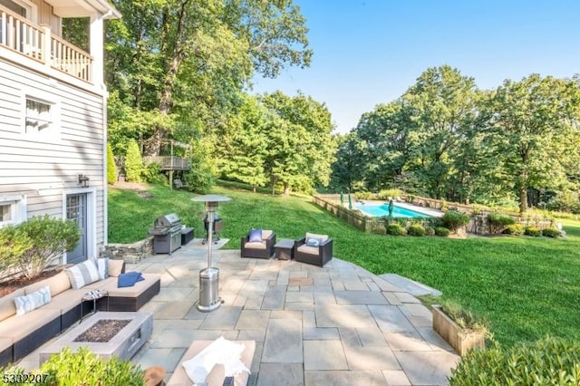 view of patio featuring a balcony, an outdoor living space with a fire pit, and grilling area