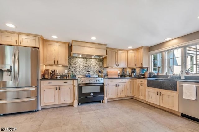 kitchen with light brown cabinetry, appliances with stainless steel finishes, sink, and custom exhaust hood