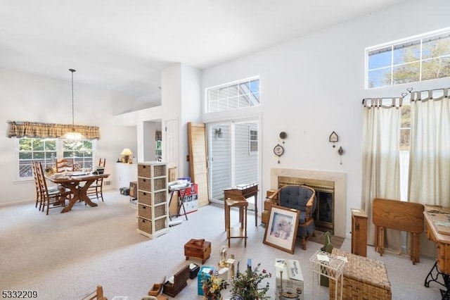 carpeted living room with a towering ceiling