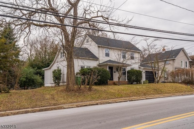 view of front of house featuring a front yard and a garage