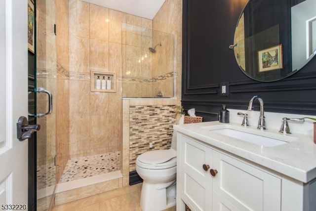 bathroom featuring tile patterned floors, an enclosed shower, vanity, and toilet