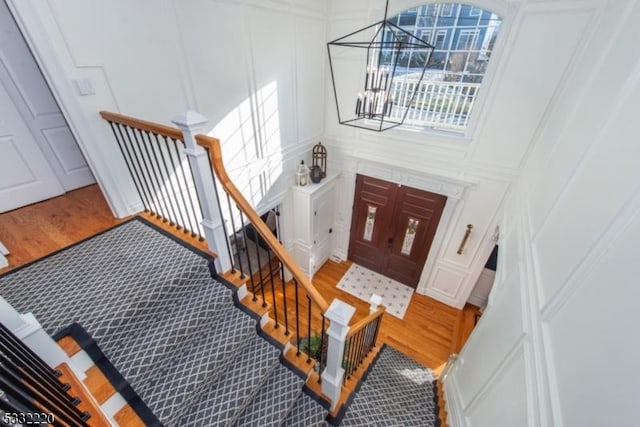 foyer with wood-type flooring and a chandelier