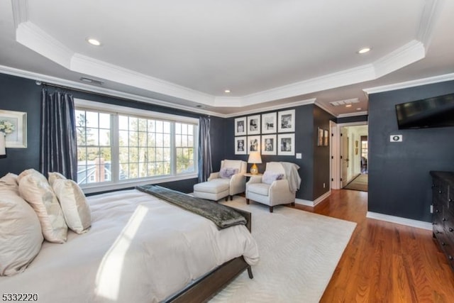 bedroom featuring a raised ceiling and crown molding