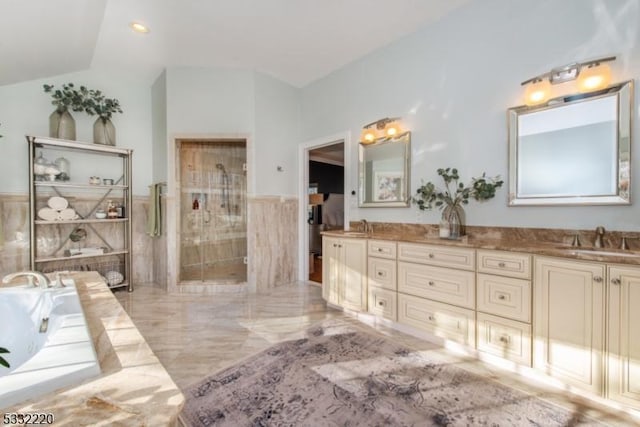 bathroom featuring shower with separate bathtub, lofted ceiling, and vanity