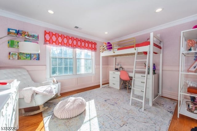 bedroom with crown molding and hardwood / wood-style floors