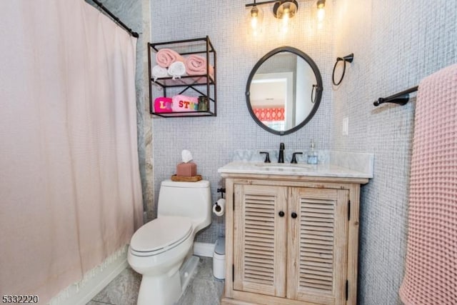 bathroom featuring tile patterned floors, toilet, vanity, and tile walls