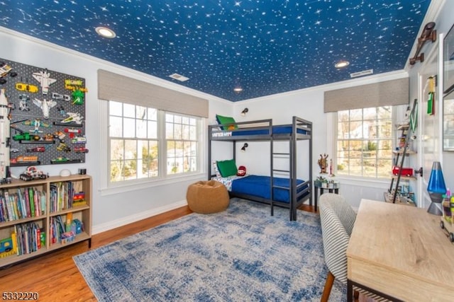 bedroom featuring wood-type flooring and crown molding