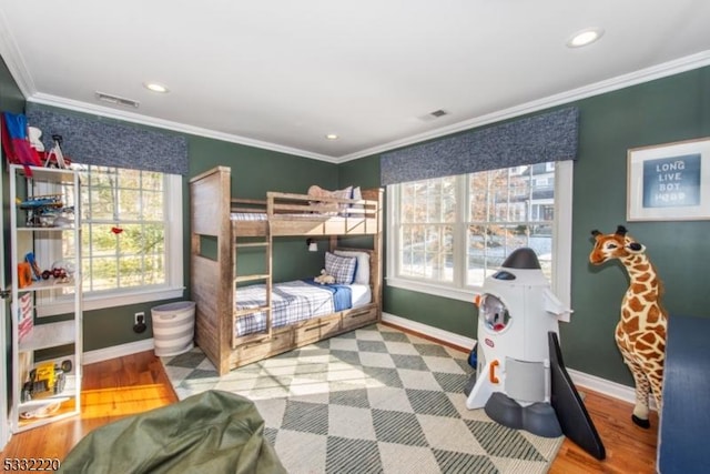 bedroom featuring wood-type flooring and crown molding