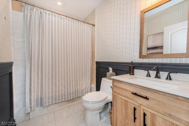 full bathroom featuring toilet, tile patterned floors, vanity, and shower / bath combo with shower curtain