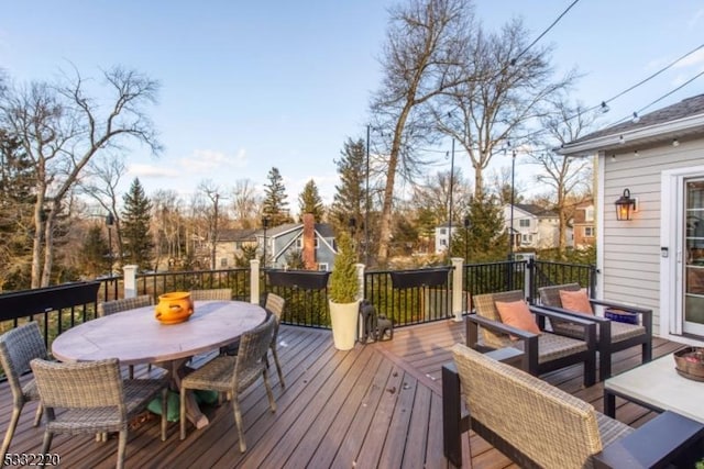 wooden terrace with an outdoor living space