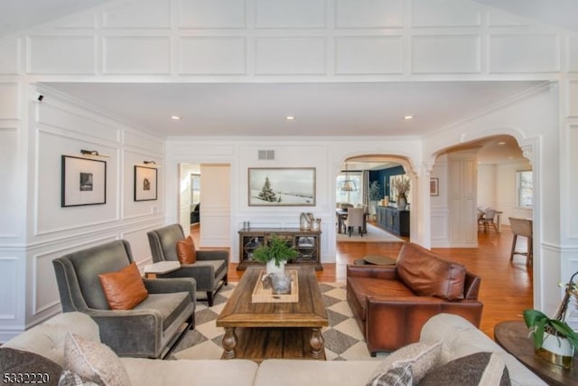 living room with ornamental molding and hardwood / wood-style flooring