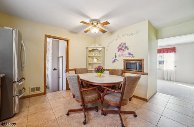 dining room with ceiling fan and light tile patterned floors