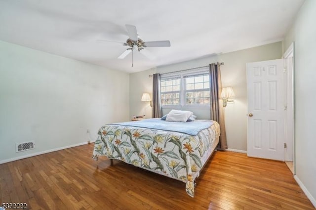 bedroom with ceiling fan and wood-type flooring