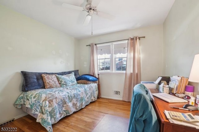 bedroom with light wood-type flooring and ceiling fan