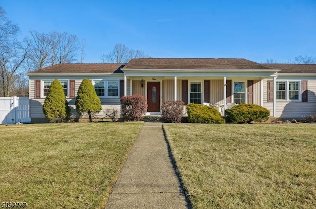 single story home with a porch and a front lawn