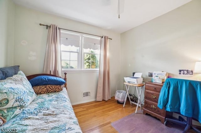 bedroom with hardwood / wood-style floors and ceiling fan