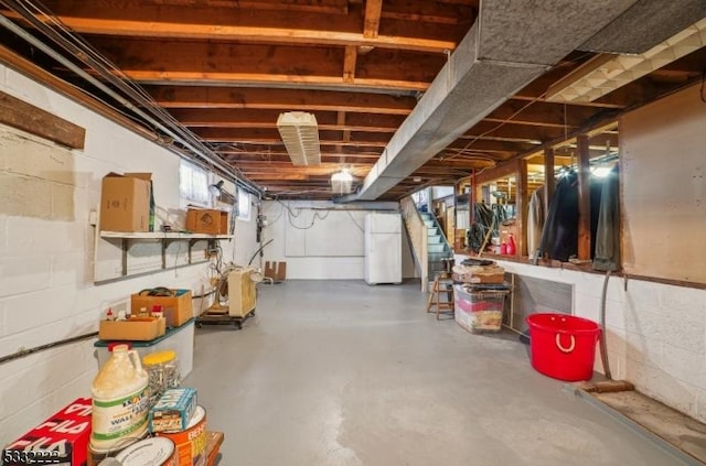 basement with white refrigerator