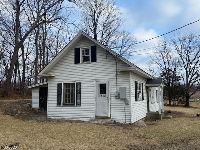 rear view of house with a yard