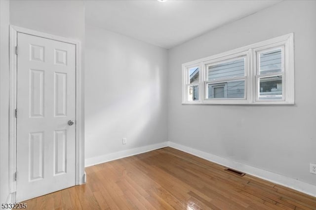 unfurnished room with light wood-type flooring