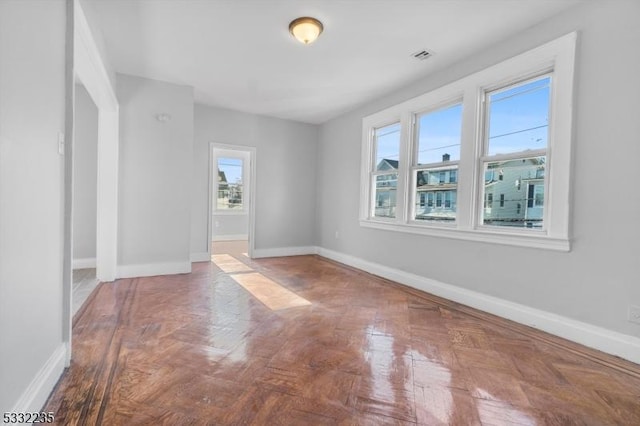 empty room with parquet flooring