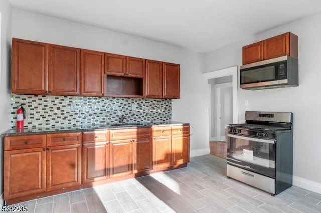 kitchen featuring sink, appliances with stainless steel finishes, and decorative backsplash