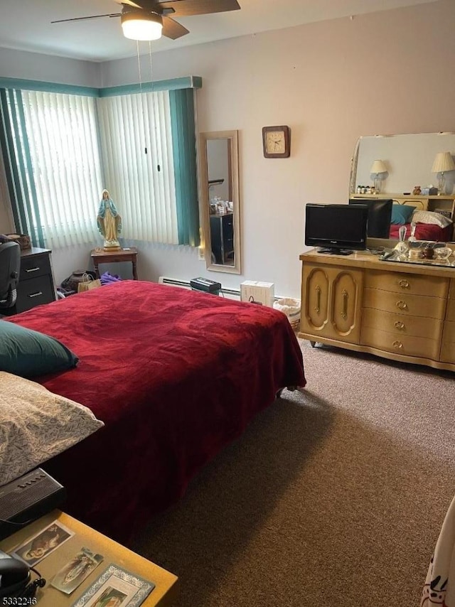 bedroom with ceiling fan, a baseboard heating unit, and carpet floors