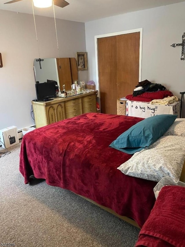 bedroom with ceiling fan, carpet flooring, and a baseboard radiator