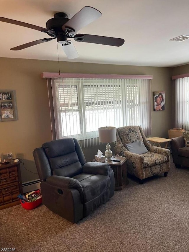 living room with ceiling fan, a baseboard radiator, and carpet flooring