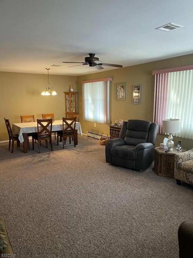 carpeted living room featuring baseboard heating and ceiling fan with notable chandelier