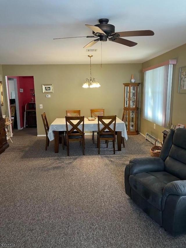 carpeted dining room featuring baseboard heating and ceiling fan with notable chandelier